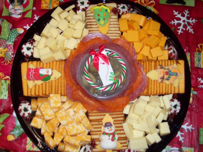 Holiday tray of cubed Colby, cheddar and marble cheeses with crackers, cookies and a dip cup in the center
